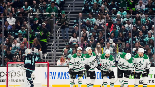 The Stars celebrate a goal by Jamie Benn against Seattle Kraken goaltender Philipp Grubauer.